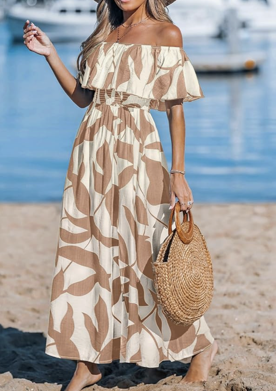Off-the-shoulder beige and brown leaf-print maxi dress on the beach