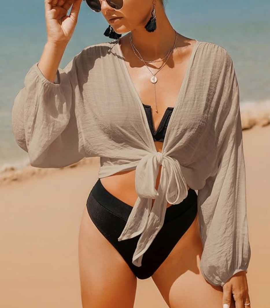 Flowy neutral coverup tied at the waist, styled on the beach