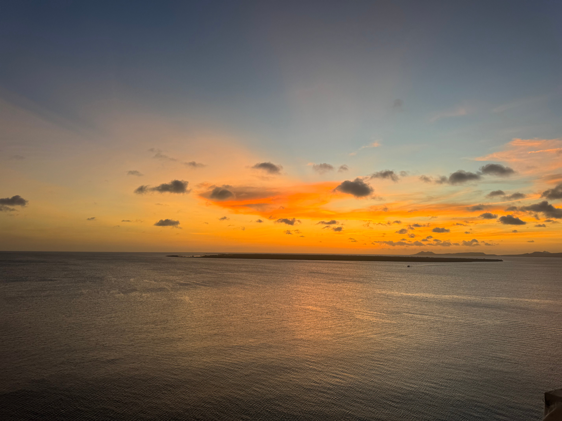 A quiet sunset over open water — the day slowing to gold